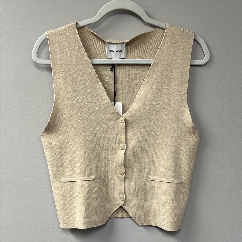 This Pink Rose brand women's button-down V-neck knit sweater vest features a cla